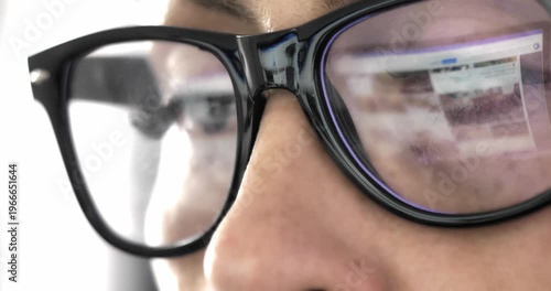 Business beautiful young woman Caucasian in glasses close-up in which the computer monitor is reflected