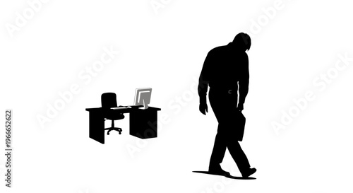 A man walks away from a desk and chair in a stark silhouette