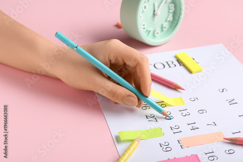 Female hand with alarm cloc...