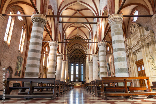 Interior of the Gothic Church of San Lorenzo in Vicenza featuring massive striped brick columns and elegant vaulted ceilings in Italy 08.01.2026