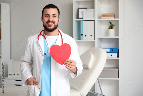Young happy male doctor wit...