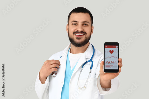 Young happy male doctor wit...