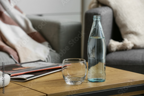 Bottle of water, glass and ...