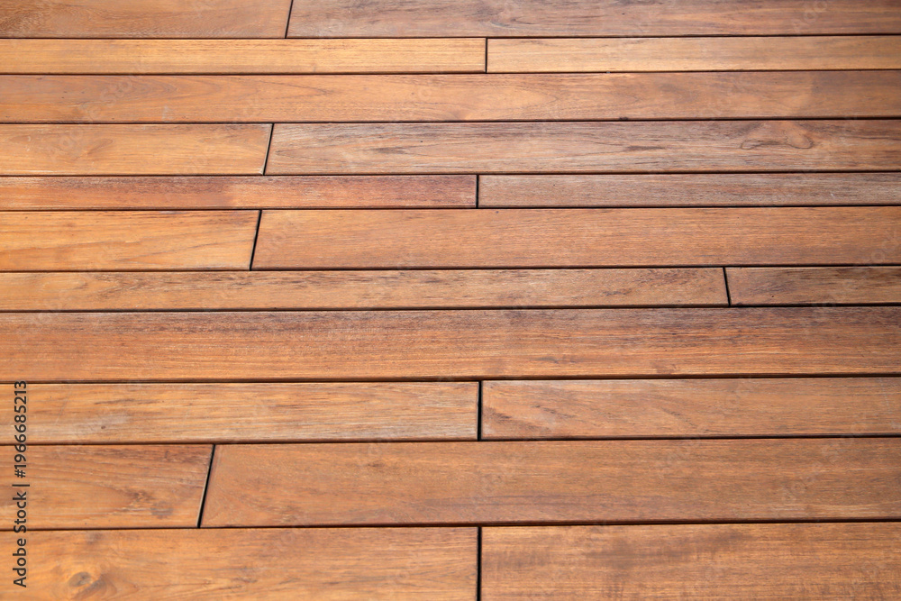 Obraz premium Wooden walkway surface with natural grain and warm brown tones.