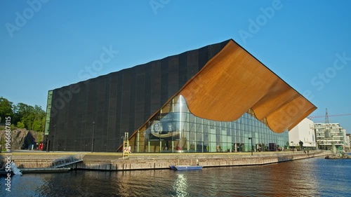 Modern waterfront building of Kilden Performing Arts Centre in Kristiansand. Contemporary architecture and harbor reflection in Norway.
