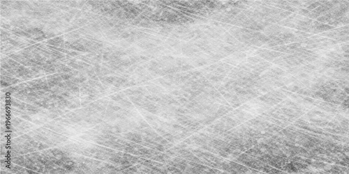 A close-up captures the textured surface of a smooth, ice rink, revealing intricate patterns of sharp, crisscrossing lines. It presents a captivating play of light and shadow.