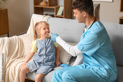 Male pediatrician examining...