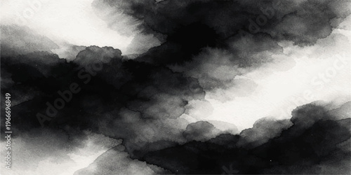 Dramatic dark storm clouds gather in a gray overcast sky as a powerful thunderstorm brings a moody nature background to the blue cloudscape