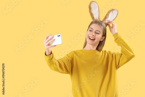 Young woman in bunny ears t...