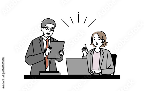 パソコンを操作しながら会話するミドル世代のビジネスマン