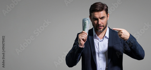 Successful business man counting money. Handsome middle age man holding bunch of 100 dollar banknotes. Guy holding money cash. Profit and financial success. Rich man with dollar cash.