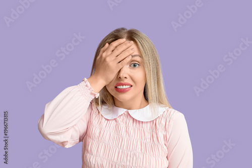 Young woman doing facepalm ...