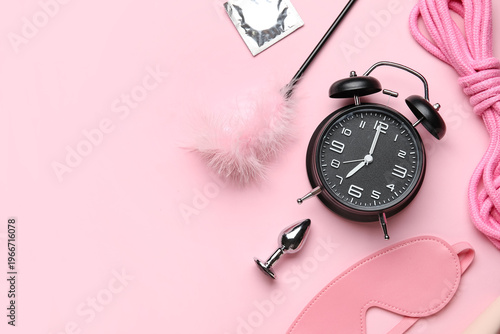 Alarm clock with sex toys a...