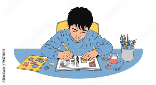 Young boy diligently drawing in his school notebook with art supplies on a desk