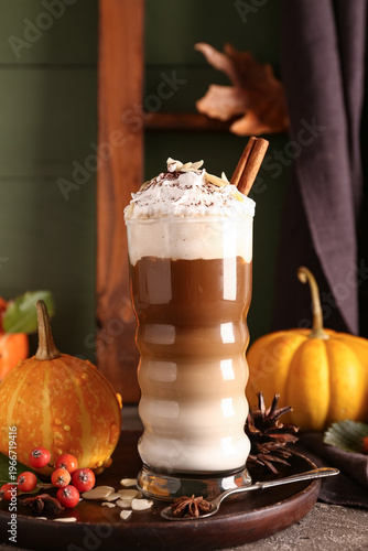 Glass of tasty pumpkin latt...