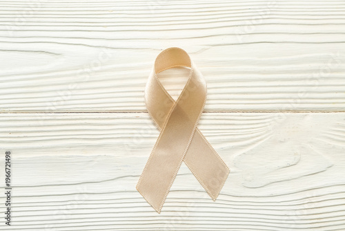 Beige ribbon on white woode...
