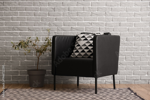 Black armchair with cushion...