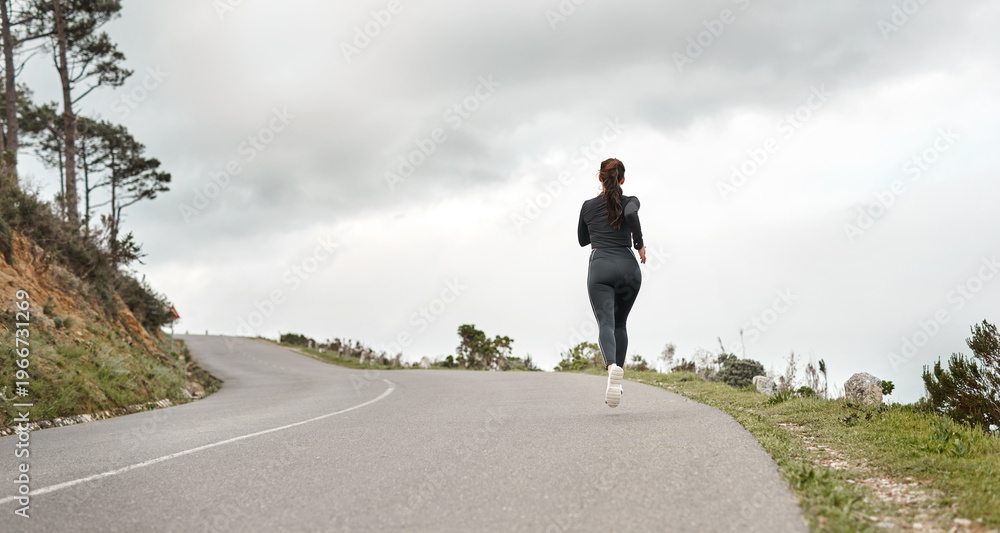 Fototapeta premium Fitness, back and person on road with running, cardio or stamina training in physical activity. Space, practice or athlete on path with jog, outdoor workout and sports endurance in New Zealand.