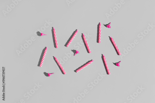 Pink birthday candles on gr...