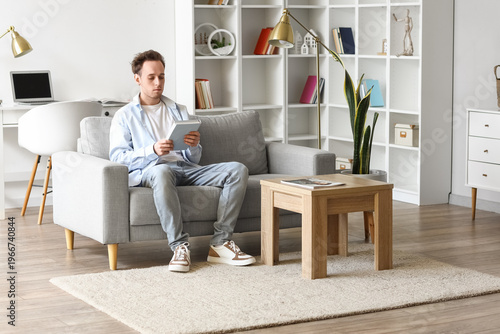 Young man with book sitting...