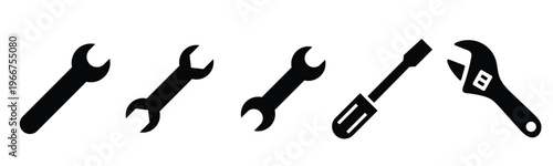 Black silhouette vector icons of essential mechanic hand tools a set of open-end wrenches a flathead screwdriver and an adjustable spanner