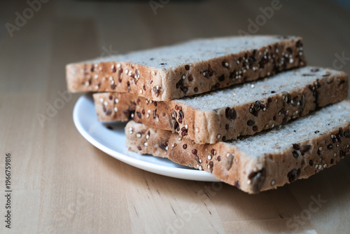 Sliced whole wheat bread on the white plate.