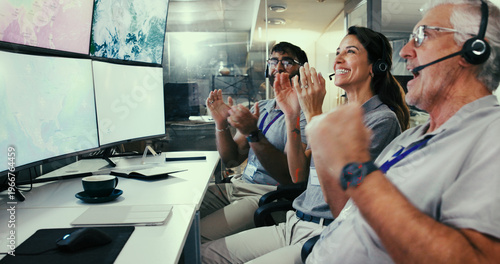 Foto Applause, computer and satellite with people in control room for team, launch success and mission target