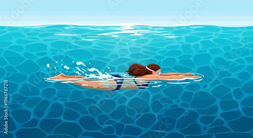 Woman swimming freestyle stroke in blue water with goggles and a striped swimsuit