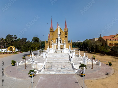Aerial view of St. Patrick's Cathedral with its distinct red spires and the white marble monument in the foreground Karachi, Sindh, Pakistan.