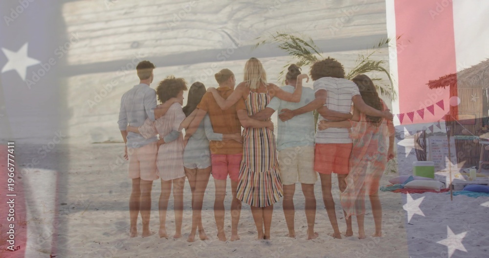 Fototapeta premium Standing eight adults linking arms on sand, wearing striped dress, showing flag overlay, cabana