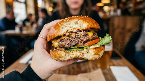 Obraz na płótnie Delicious beef burger with melted cheese and fresh lettuce in natural light
