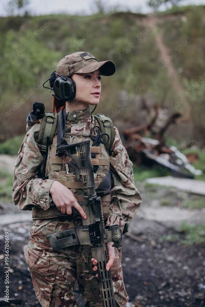 Fototapeta premium Portrait of a female Ukrainian soldier with a rifle