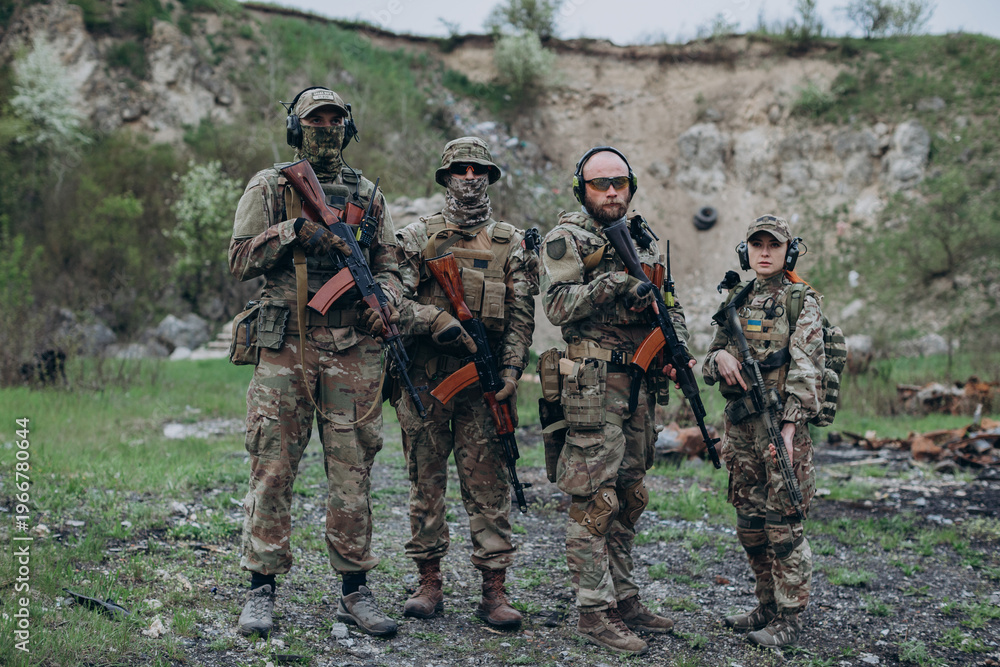 Fototapeta premium Armed group of Ukrainian soldiers posing for camera at the range