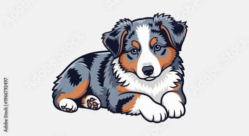 A fluffy tri-color puppy with blue eyes lies calmly, looking forward