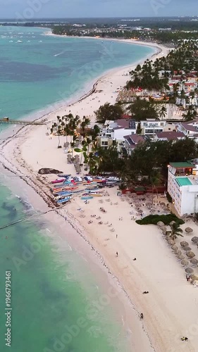 Flight over popular tourist coastline at dusk, city lights. Dominican Republic
