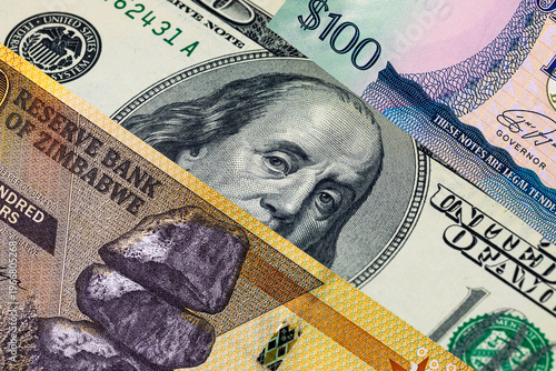 Foto Different 100 Dollars banknotes from the USA, Guyana, and Zimbabwe
