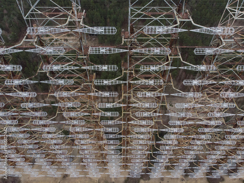 Aerial view of the massive Duga radar station steel lattice structure and dipole antennas surrounded by forest in Pryp'yat', Kyiv Oblast, Ukraine.