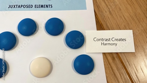 Five Blue Dots and One Cream Dot on Paper