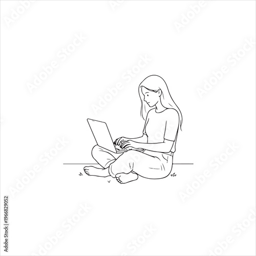 A woman sitting on the floor with a laptop