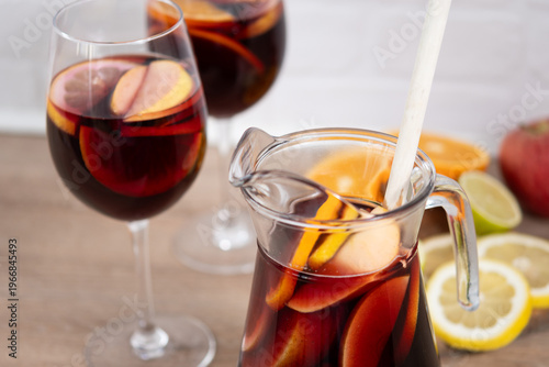 Sangria cocktail with fresh fruit on wooden table