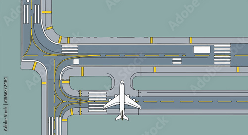 Aerial view of an airport taxiway with an airplane approaching a runway intersection