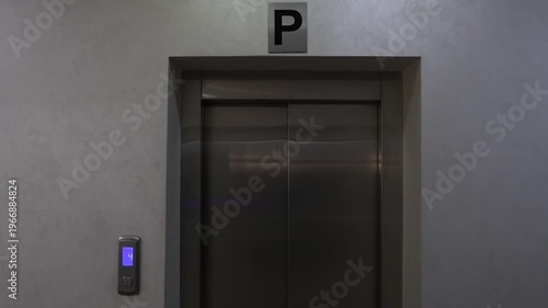 Steel Facade With Blue Button. Silent Industrial Ambiance With Recessed Lighting