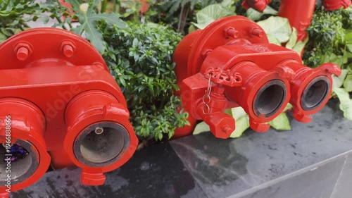 Red Safety Equipment features dual threaded outlets and top operating nut. Tropical garden uses Safety Equipment with cast iron valves and bolted flange for reliable firefighting.