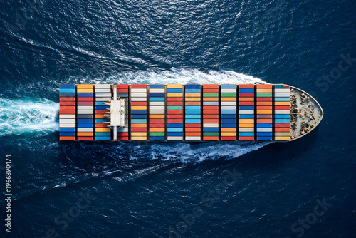 Aerial top view of container ship carrying cargo across the blue ocean, global logistics and maritime transportation