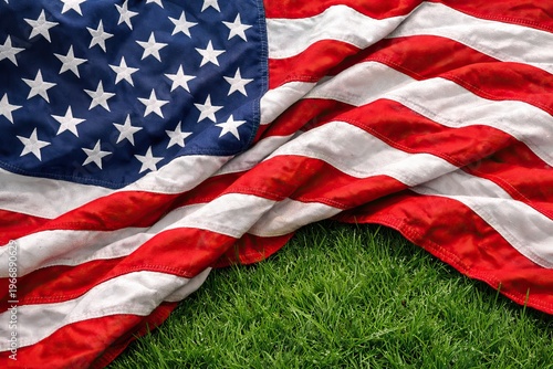 American flag on green grass background, patriotic USA flag with stars and stripes, national holiday celebration banner for Memorial Day or July 4th