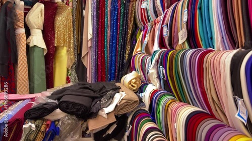 Energetic Retail Space Featuring Variety Of Luxurious Textiles And Elegant Dress Displays