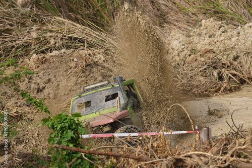 Red Pickup off road  4WD spin mud dirty track on mountain hill.     