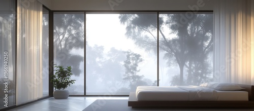 Modern bedroom with large windows overlooking foggy forest