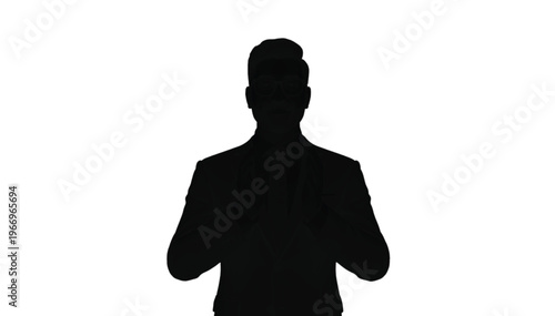 Male silhouette in a suit stands facing forward with hands held together near the waist area.