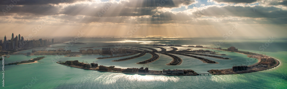 custom made wallpaper toronto digitalPanoramic helicopter view of Palm Jumeirah at sunset with dramatic sunlight breaking through clouds and urban skyline